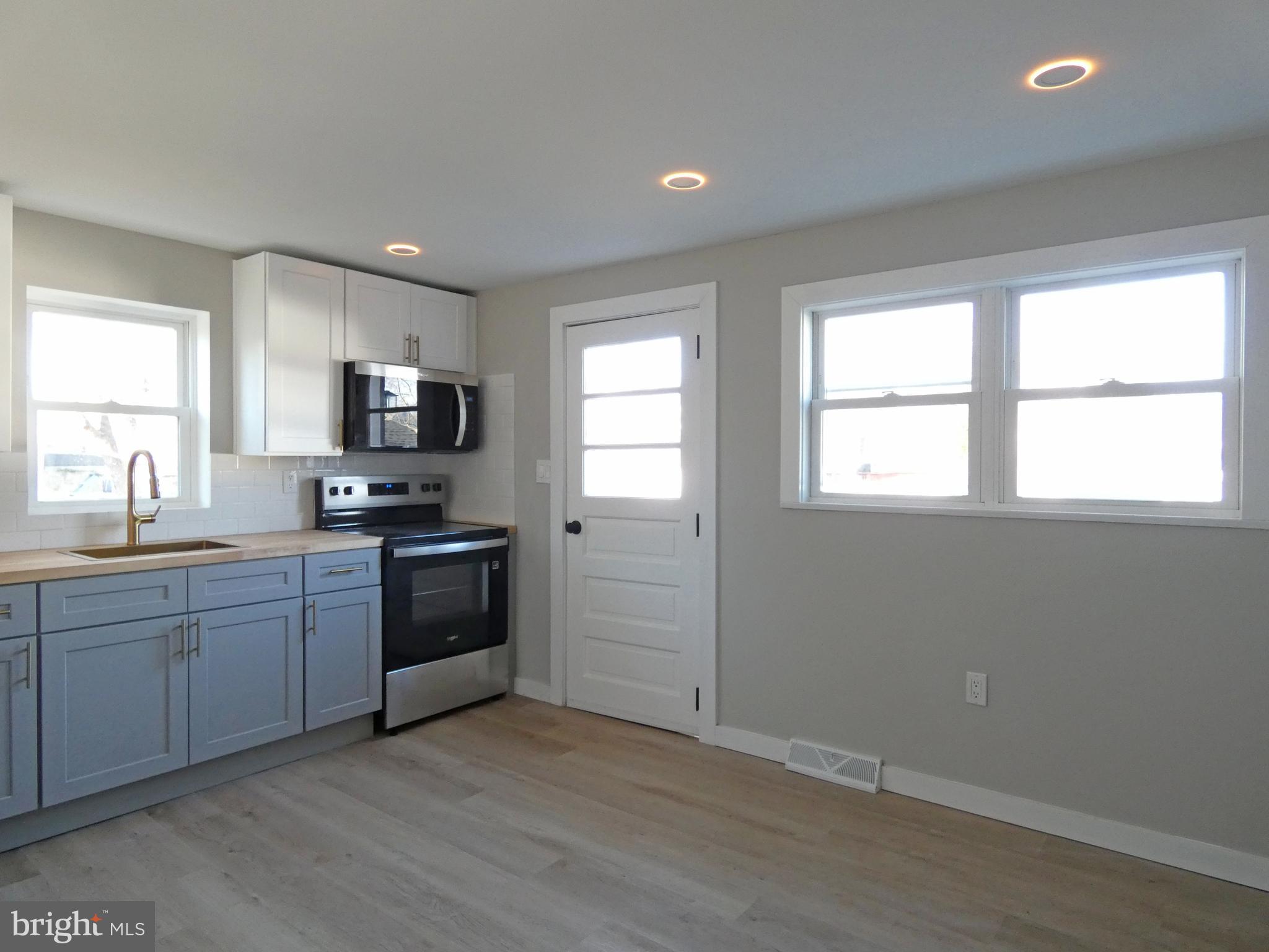 411 Manor Avenue Carneys Point, NJ 08069 - Photo 23 of 50 a kitchen with sink a microwave and cabinets