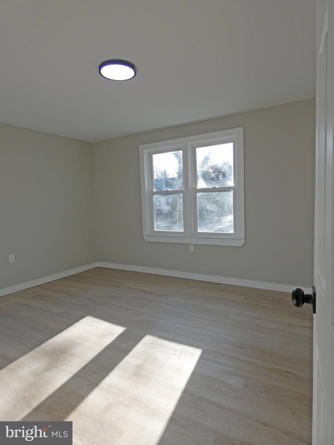 411 Manor Avenue Carneys Point, NJ 08069 - Photo 24 of 50 an empty room with wooden floor and windows