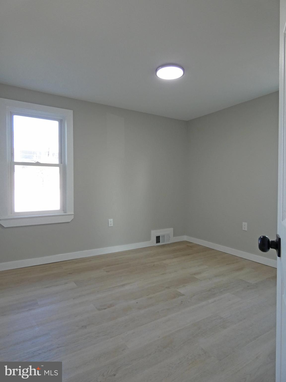 411 Manor Avenue Carneys Point, NJ 08069 - Photo 29 of 50 a view of an empty room with wooden floor and a window