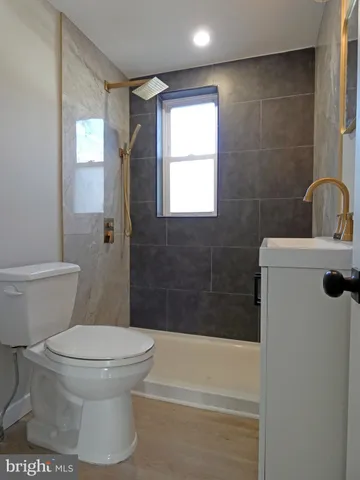 a bathroom with a toilet a sink and bathtub