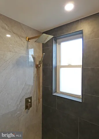 a bathroom with a shower and a window