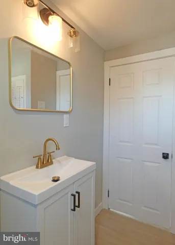 a bathroom with a sink a vanity and a mirror