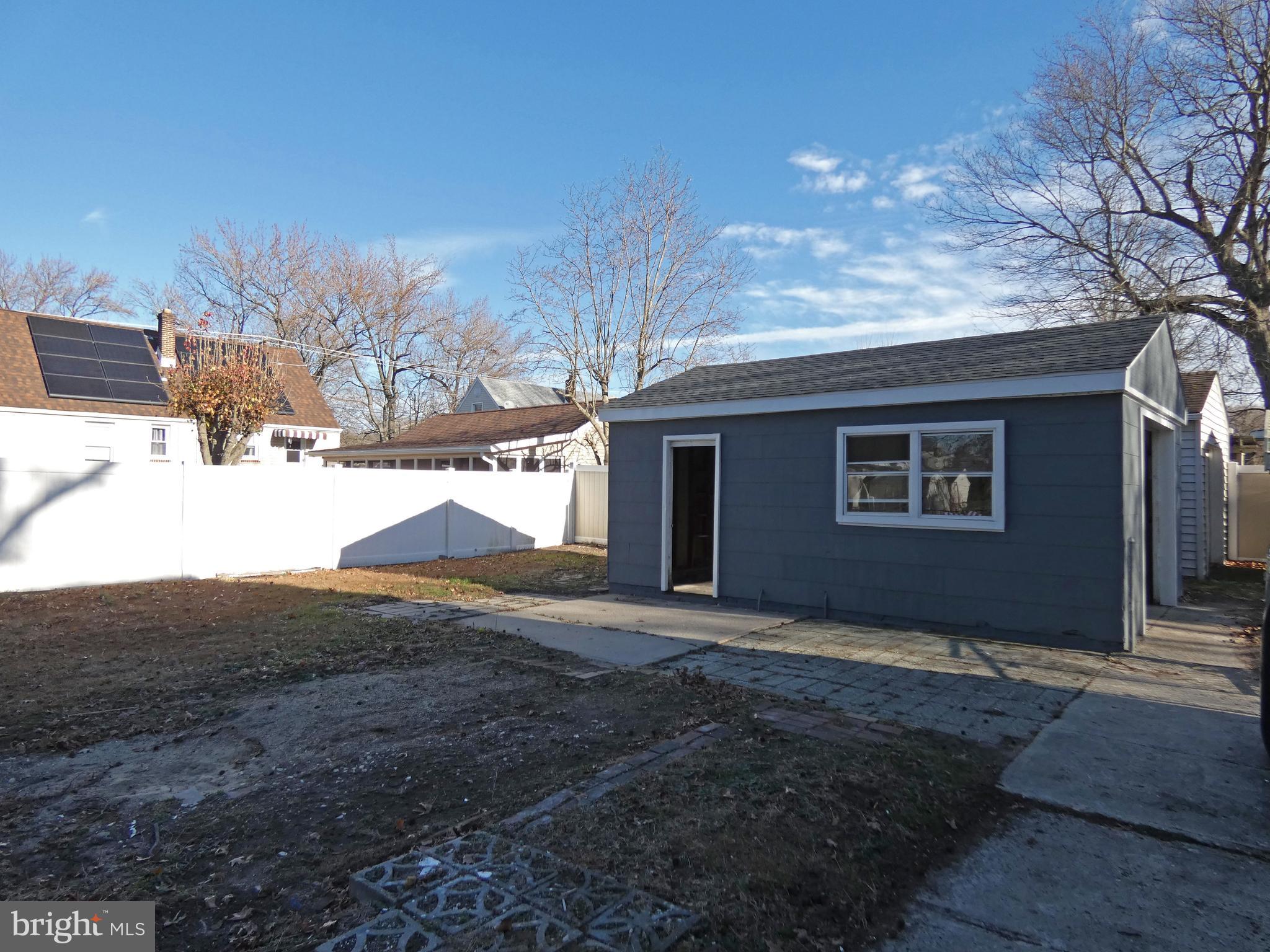 411 Manor Avenue Carneys Point, NJ 08069 - Photo 47 of 50 a backyard of a house with large trees