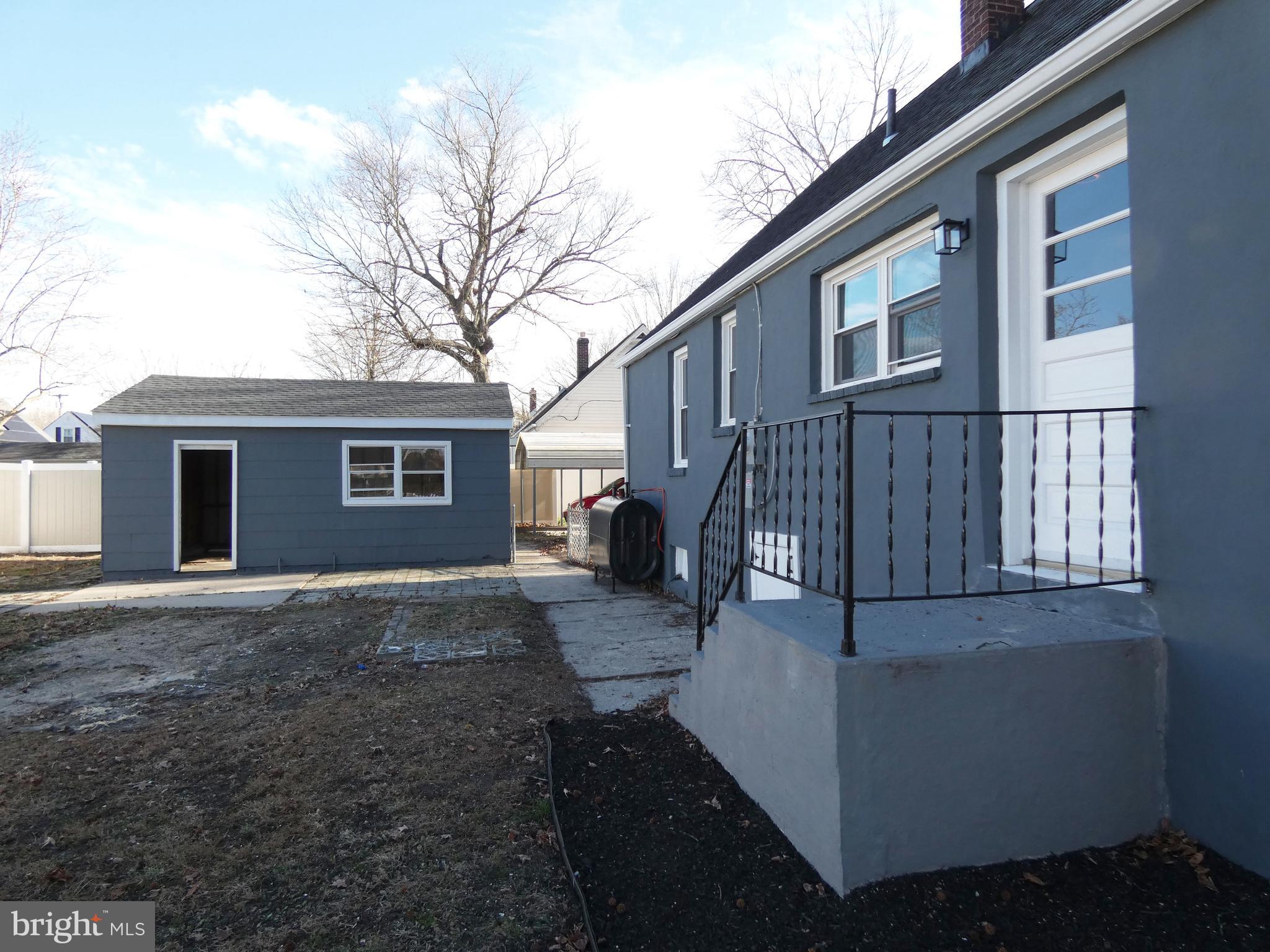 411 Manor Avenue Carneys Point, NJ 08069 - Photo 49 of 50 a view of backyard of house with outdoor seating and barbeque oven