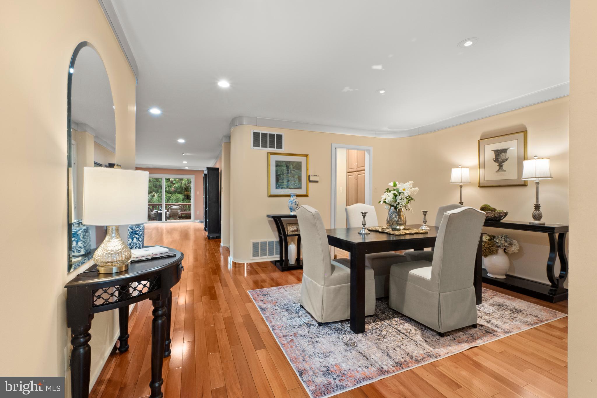 6315 Manchester Way Alexandria, VA 22312 - Photo 3 of 51 a living room with furniture a dining table and wooden floor