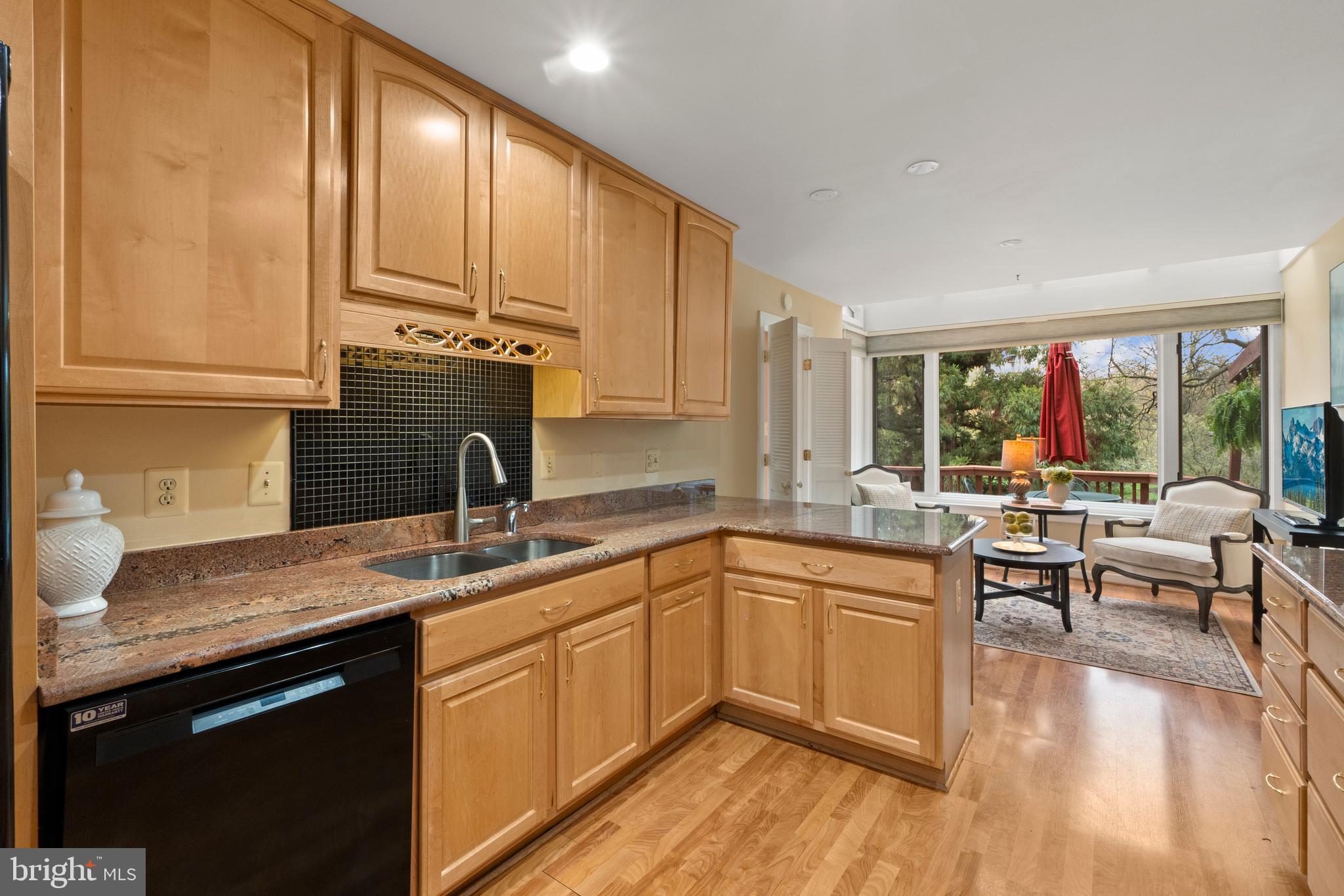 6315 Manchester Way Alexandria, VA 22312 - Photo 5 of 51 a kitchen with a sink dishwasher a stove and white cabinets with wooden floor