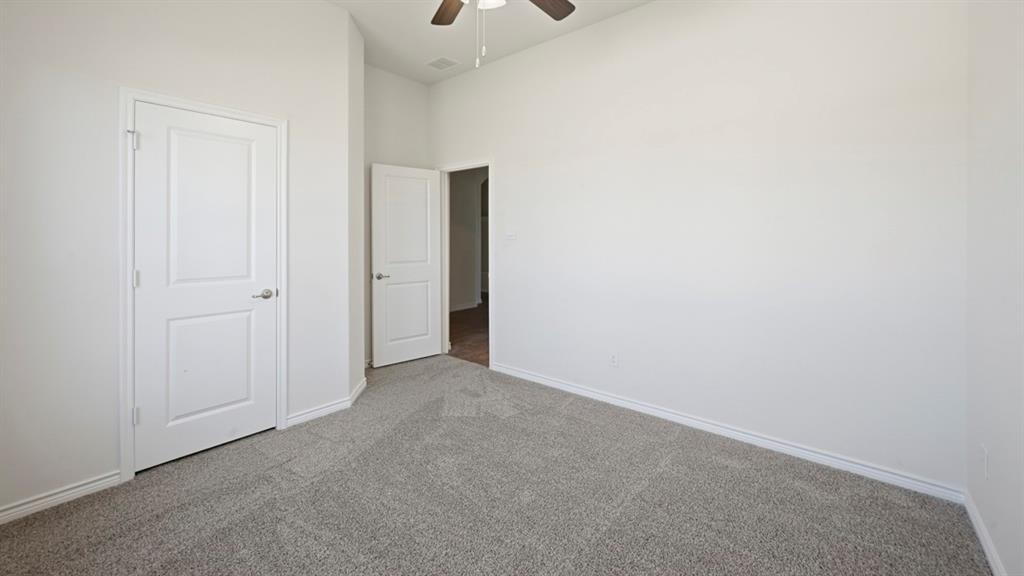 4163 Waldron Trail Forney, TX 75126 - Photo 18 of 30 Spacious room with gray textured carpeting and crisp white baseboards