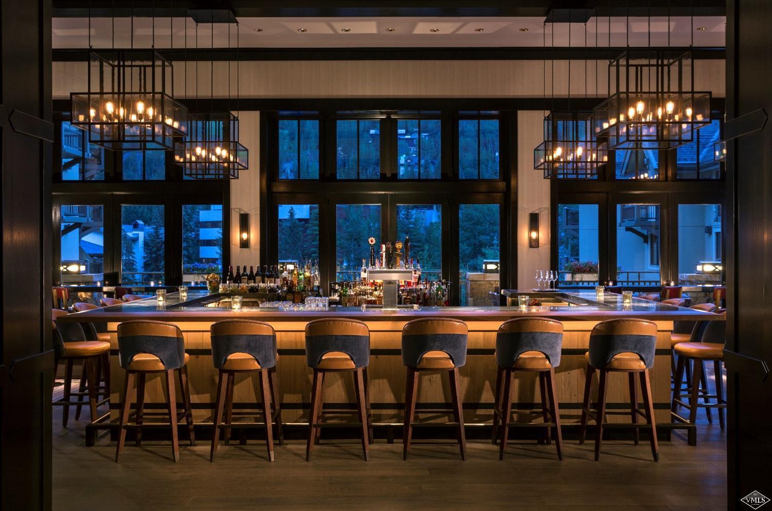 1 Vail Road, Unit 6101 Vail, CO 81657 - Photo 16 of 23 a group of people sitting in front of a store