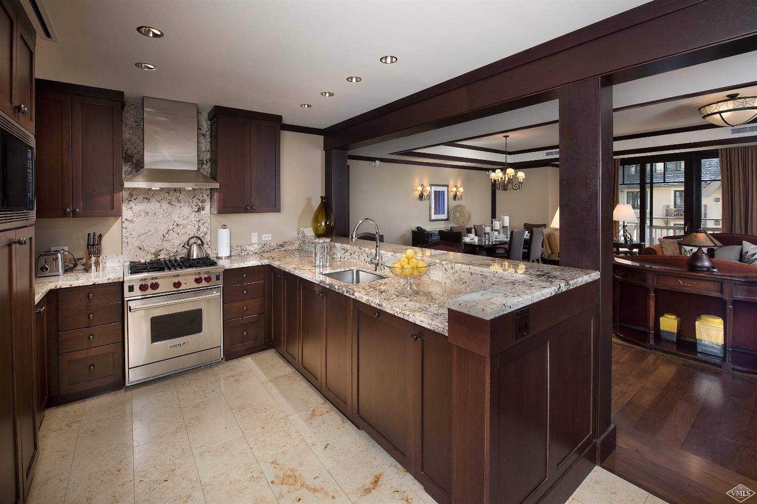 1 Vail Road, Unit 6101 Vail, CO 81657 - Photo 6 of 23 a kitchen with a stove sink and cabinets