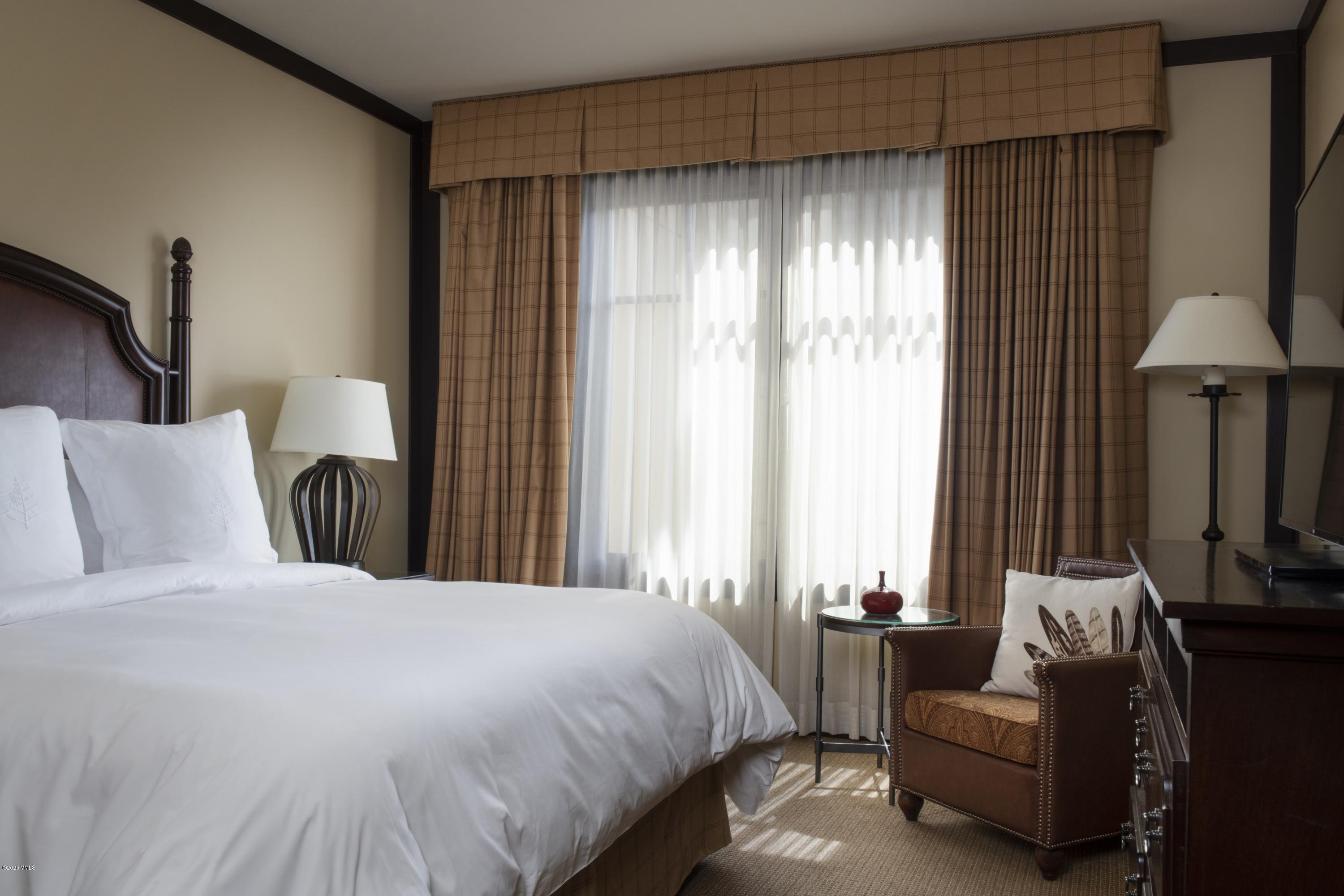 1 Vail Road, Unit 6101 Vail, CO 81657 - Photo 7 of 23 a spacious bedroom with a bed and a couch