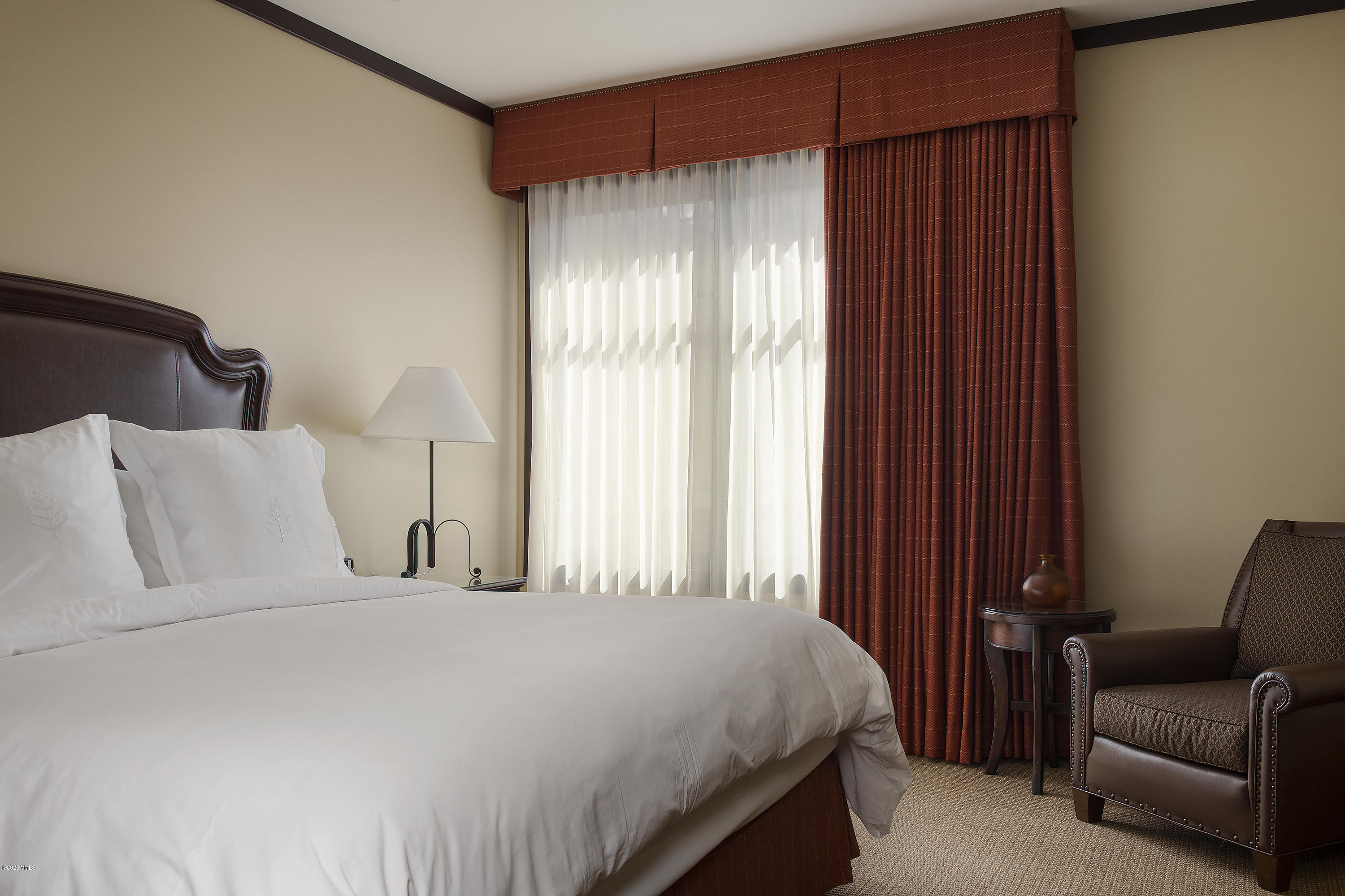 1 Vail Road, Unit 6101 Vail, CO 81657 - Photo 9 of 23 a bedroom with a bed and a chair