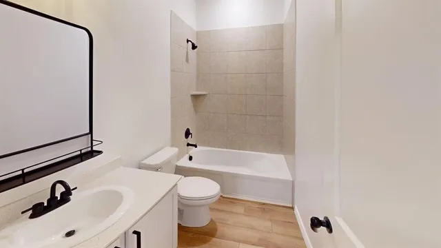 a bathroom with a sink a toilet and bathtub