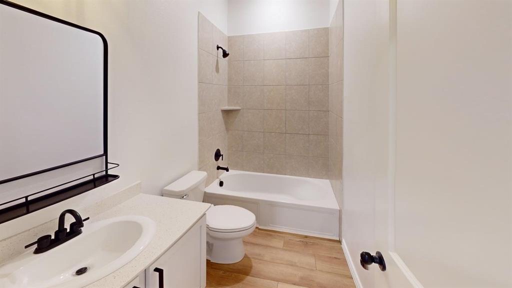 749 Twinvale Drive Princeton, TX 75407 - Photo 18 of 23 a bathroom with a sink a toilet and bathtub