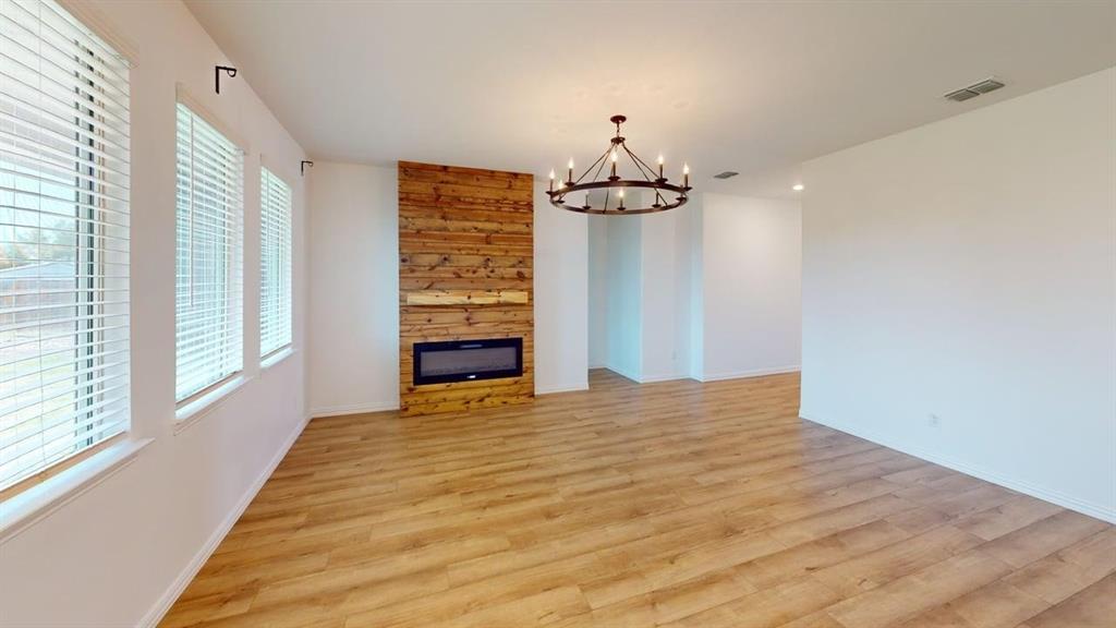 749 Twinvale Drive Princeton, TX 75407 - Photo 4 of 23 a view of empty room with wooden floor and fan