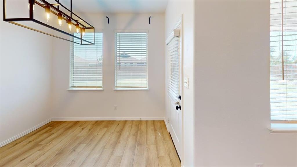 749 Twinvale Drive Princeton, TX 75407 - Photo 6 of 23 a view of a room with wooden floor and windows