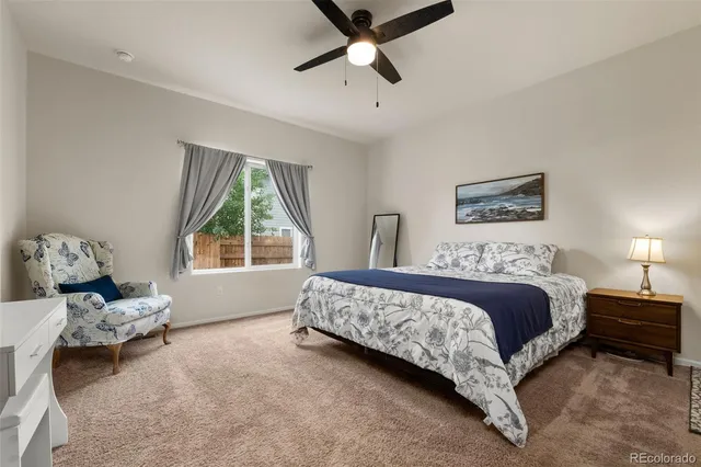 a spacious bedroom with a bed and a window