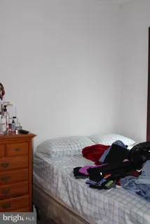 a bedroom with a bed and cabinet