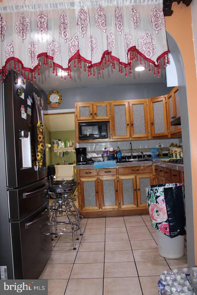 3028 North 4th Street Philadelphia, PA 19133 - Photo 6 of 15 a kitchen with stainless steel appliances kitchen island granite countertop a refrigerator and stove