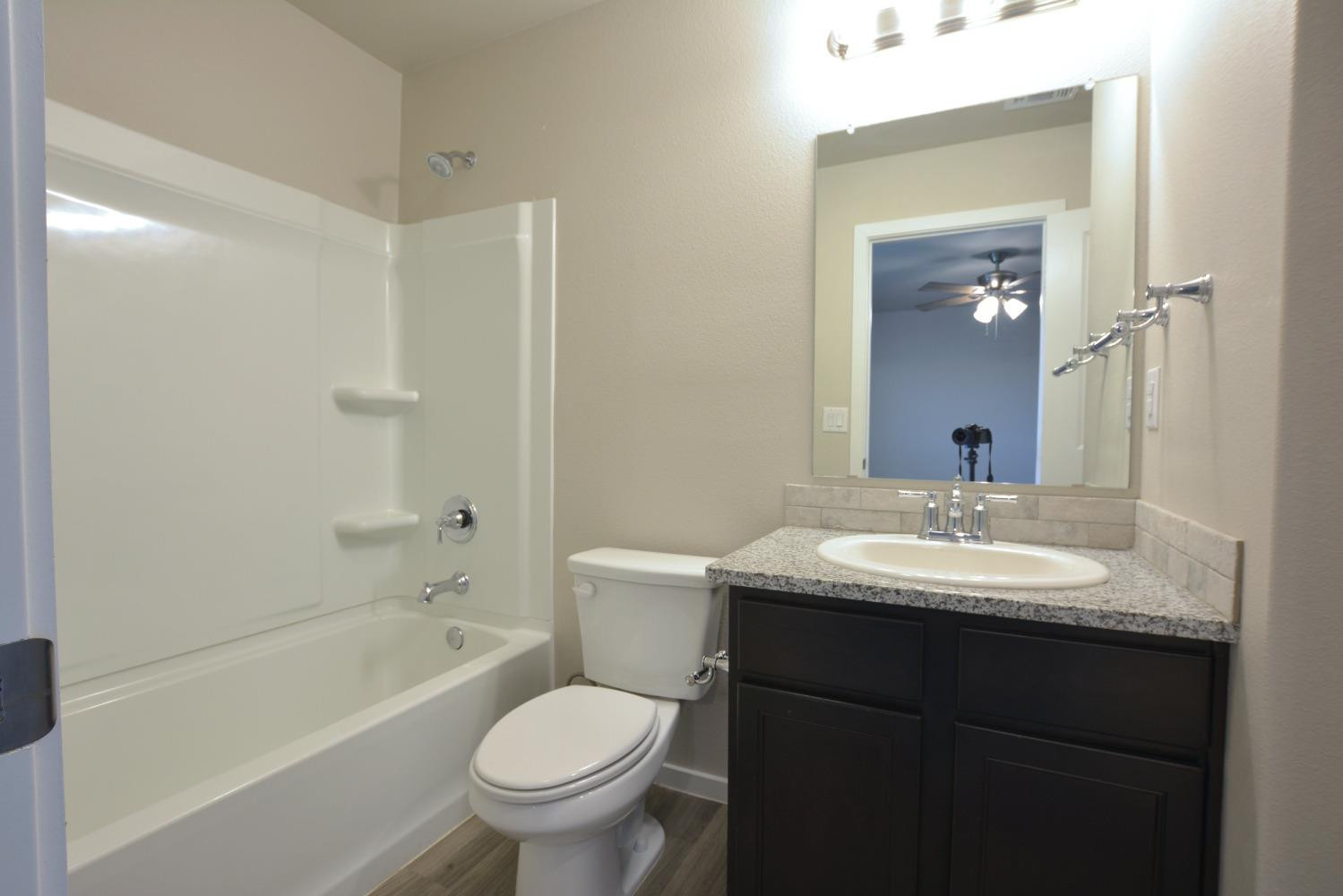 7513 28th Street Lubbock, TX 79407 - Photo 13 of 18 a bathroom with a sink toilet tub and vanity