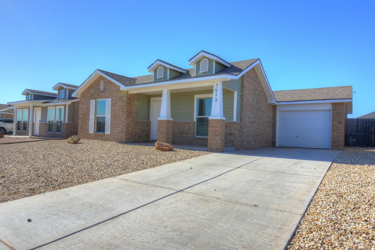 7513 28th Street Lubbock, TX 79407 - Photo 2 of 18 a front view of a house with yard