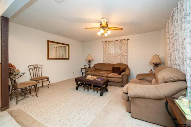 a living room with furniture a rug and a chandelier