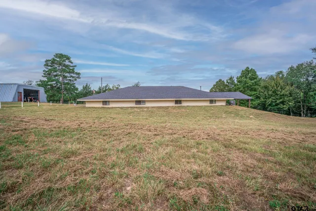 a view of a big yard with an buildings in the background