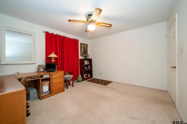 a view of a livingroom with workspace and a window