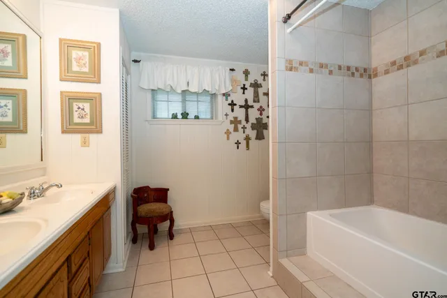 a bathroom with a sink a mirror and a shower