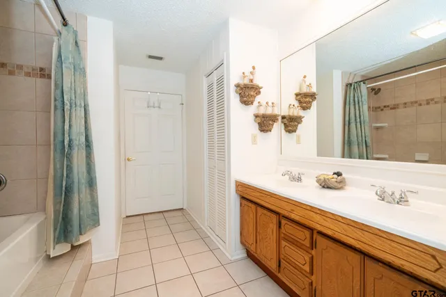 a bathroom with a tub shower and sink