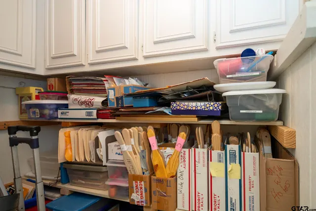 a view of a kitchen with white cabinets and a stove top oven