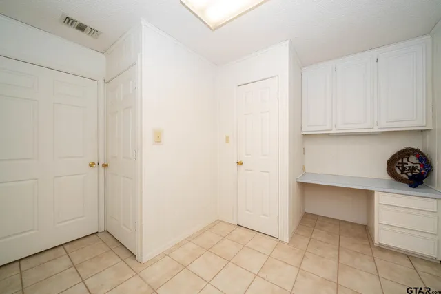 a bedroom with a balcony a bed and a window