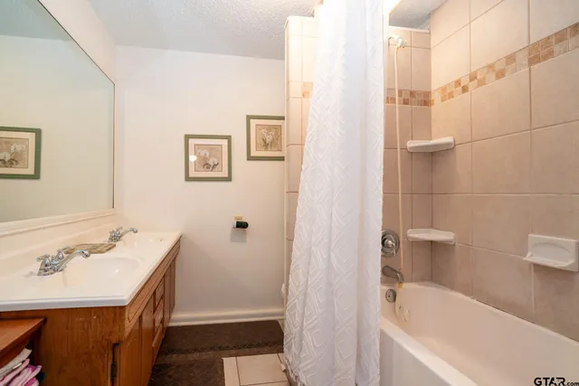 a bathroom with a sink cabinets and a window