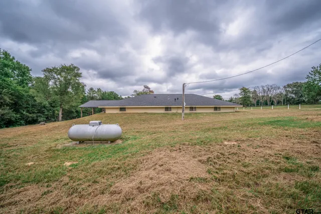 a view of a swimming pool and a yard
