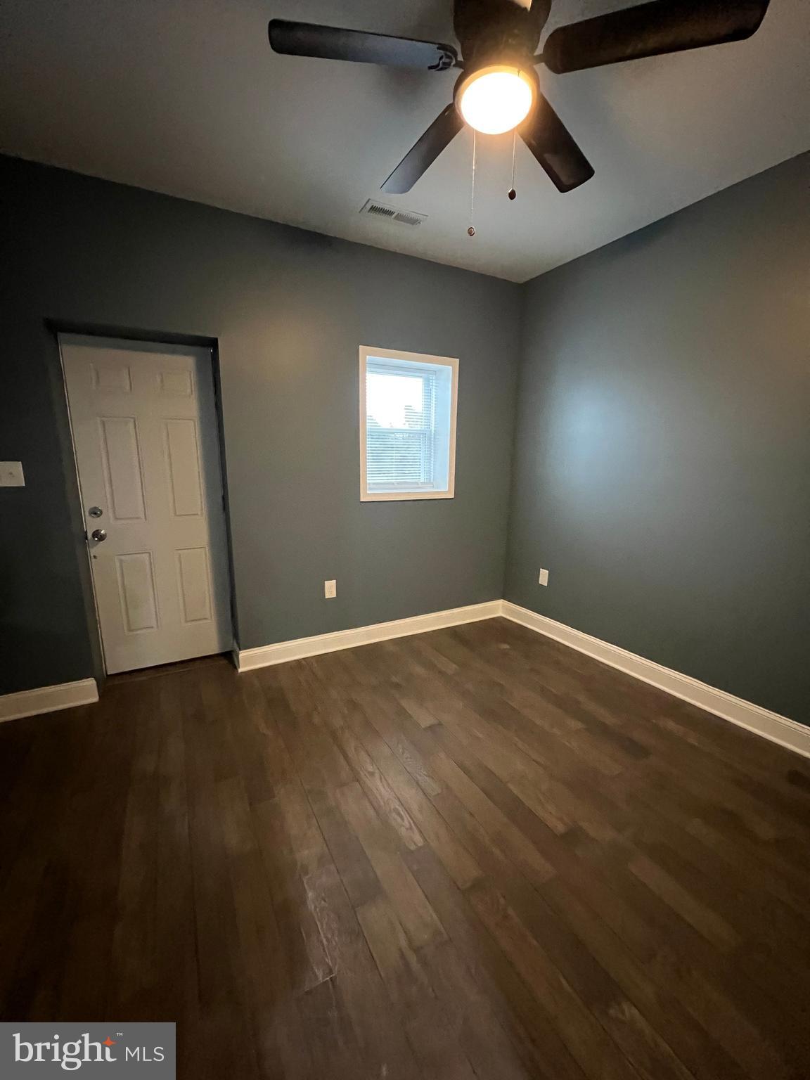 2020 McCulloh Street, Unit 2 Baltimore, MD 21217 - Photo 11 of 12 an empty room with wooden floor and windows