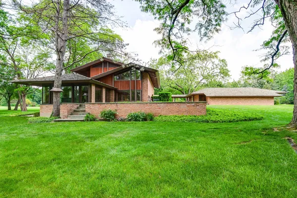 a view of a house with a yard porch and sitting area