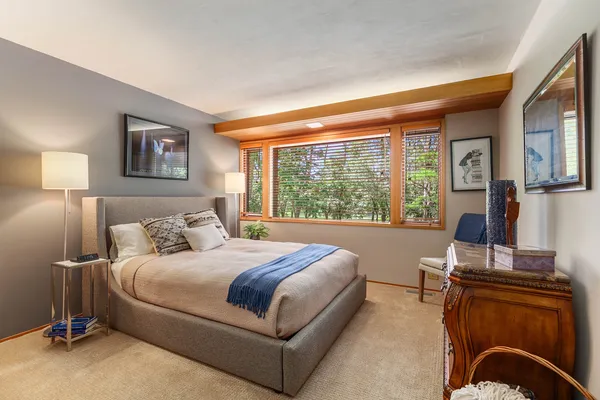 a bedroom with a large bed and a desk