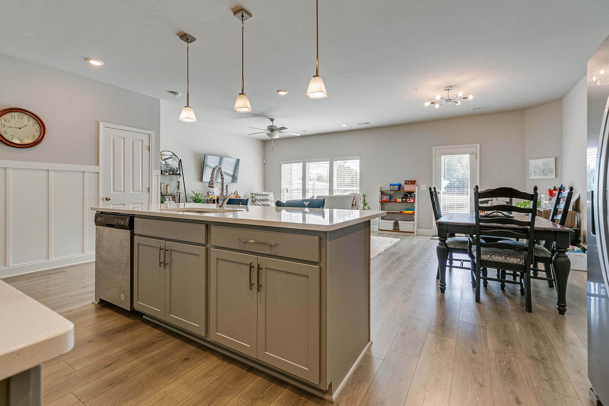 1206 June Wilde Ridge Spring Hill, TN 37174 - Photo 14 of 43 a kitchen with stainless steel appliances kitchen island granite countertop a stove a sink a dining table and chairs with wooden floor