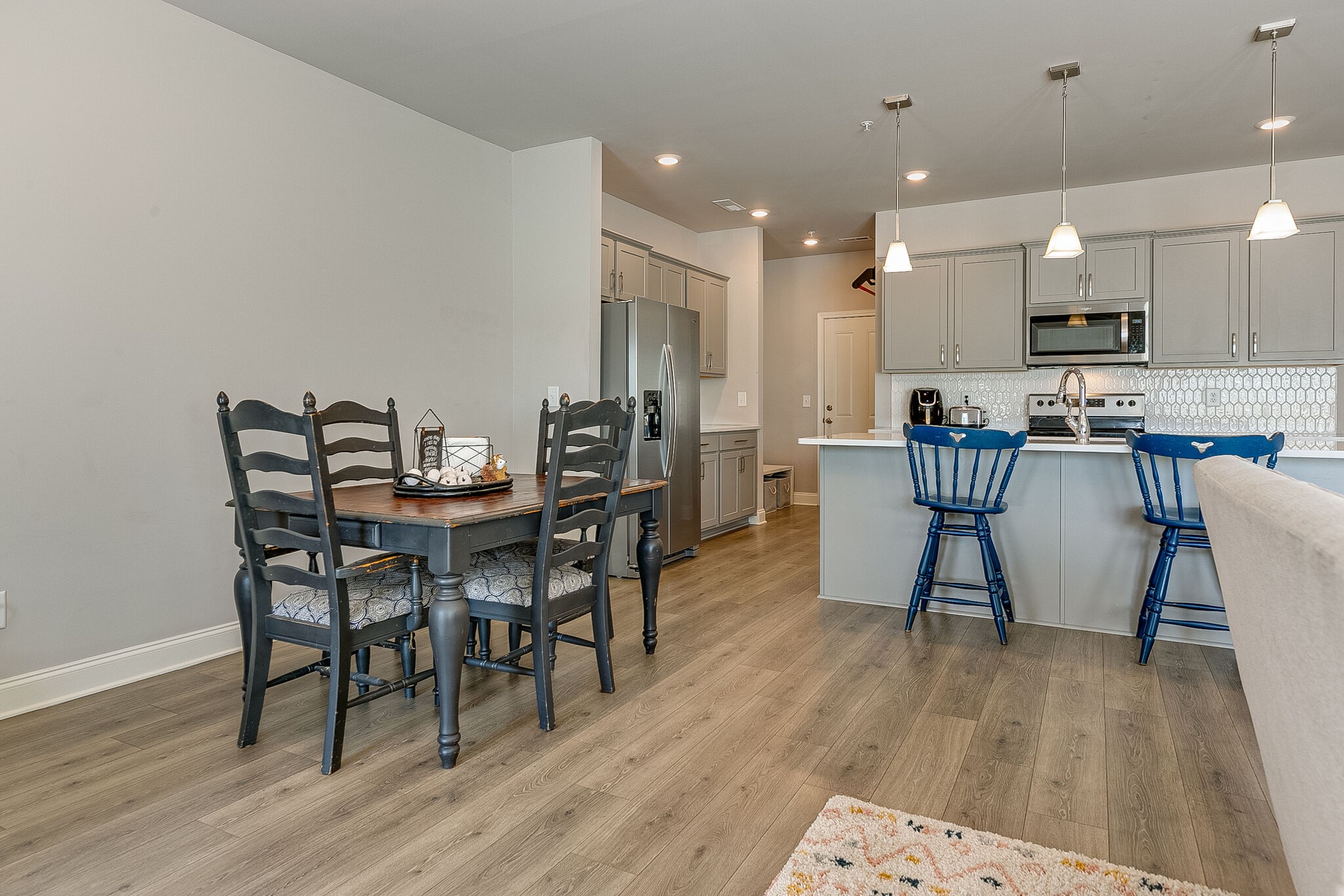 1206 June Wilde Ridge Spring Hill, TN 37174 - Photo 19 of 43 a view of a dining room with furniture and wooden floor