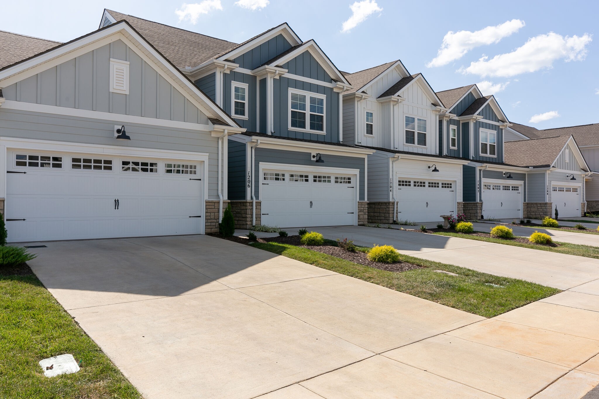 1206 June Wilde Ridge Spring Hill, TN 37174 - Photo 2 of 43 a view of a white house with a small yard and large windows