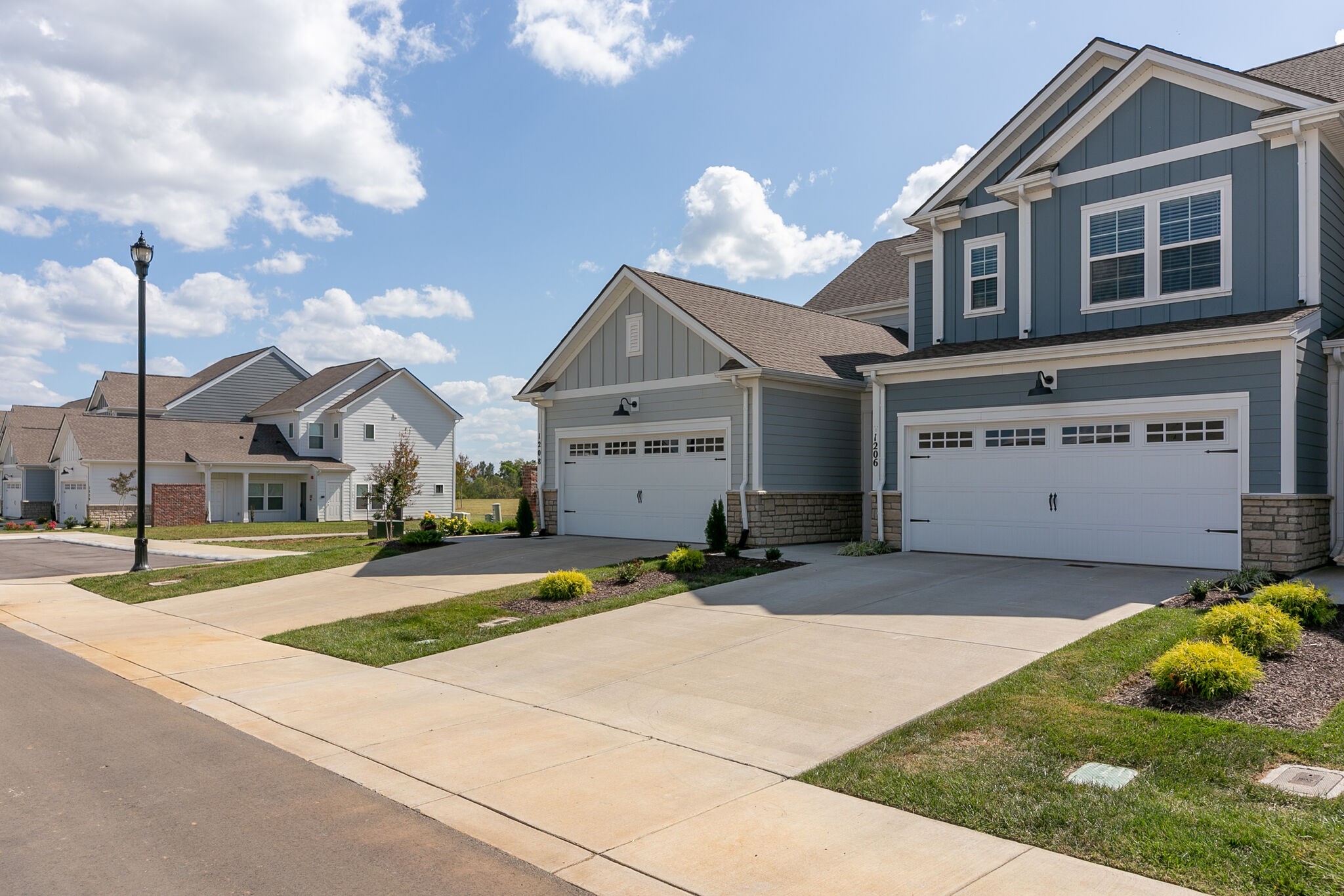 1206 June Wilde Ridge Spring Hill, TN 37174 - Photo 3 of 43 a front view of a house with a yard and garage