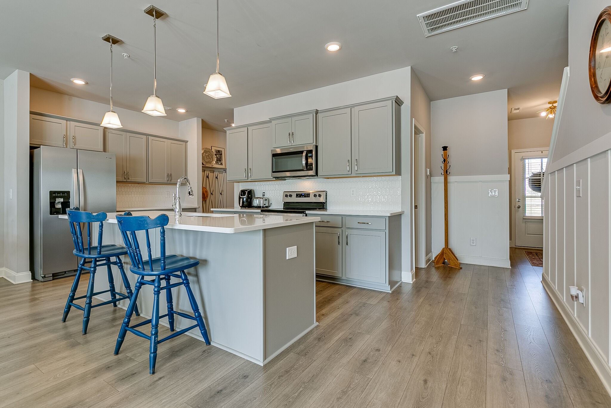1206 June Wilde Ridge Spring Hill, TN 37174 - Photo 10 of 43 a kitchen with kitchen island white cabinets and stainless steel appliances