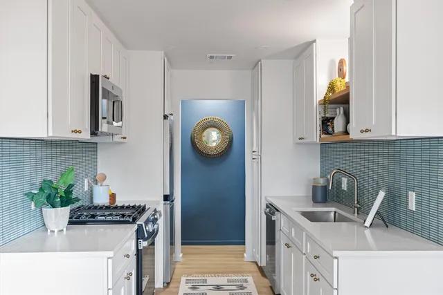a kitchen with stainless steel appliances a counter space and a window