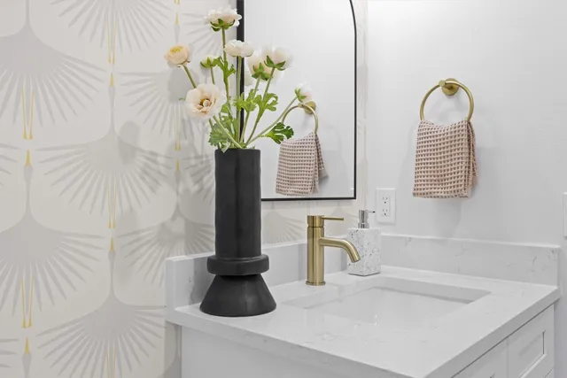 a bed sitting in a bedroom next to a window