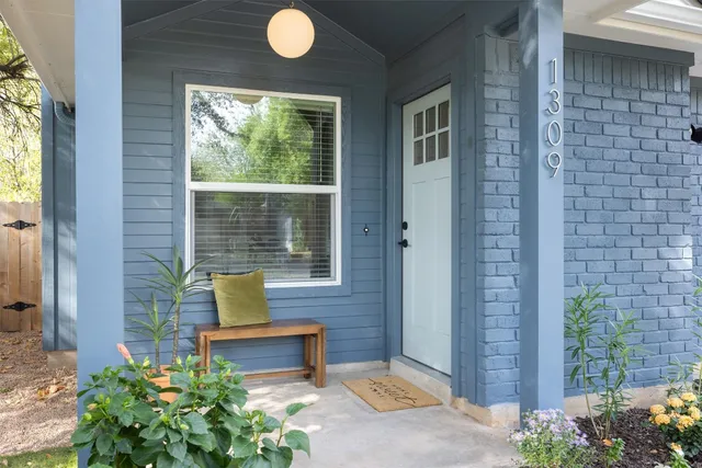 a kitchen with stainless steel appliances granite countertop a sink a stove and a wooden floors