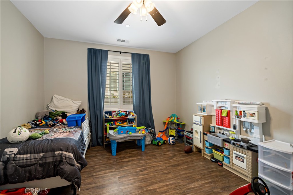 30640 Lone Pine Drive Menifee, CA 92584 - Photo 12 of 48 a living room with furniture a baby crib and a couch
