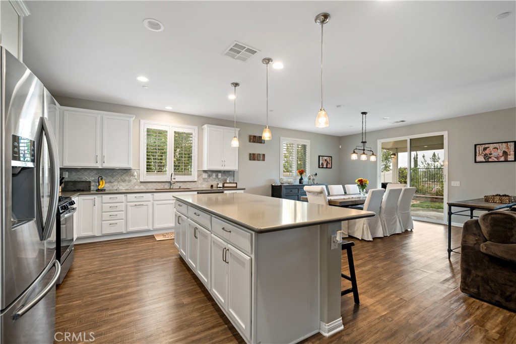 30640 Lone Pine Drive Menifee, CA 92584 - Photo 15 of 48 a kitchen with a sink stove cabinets and refrigerator