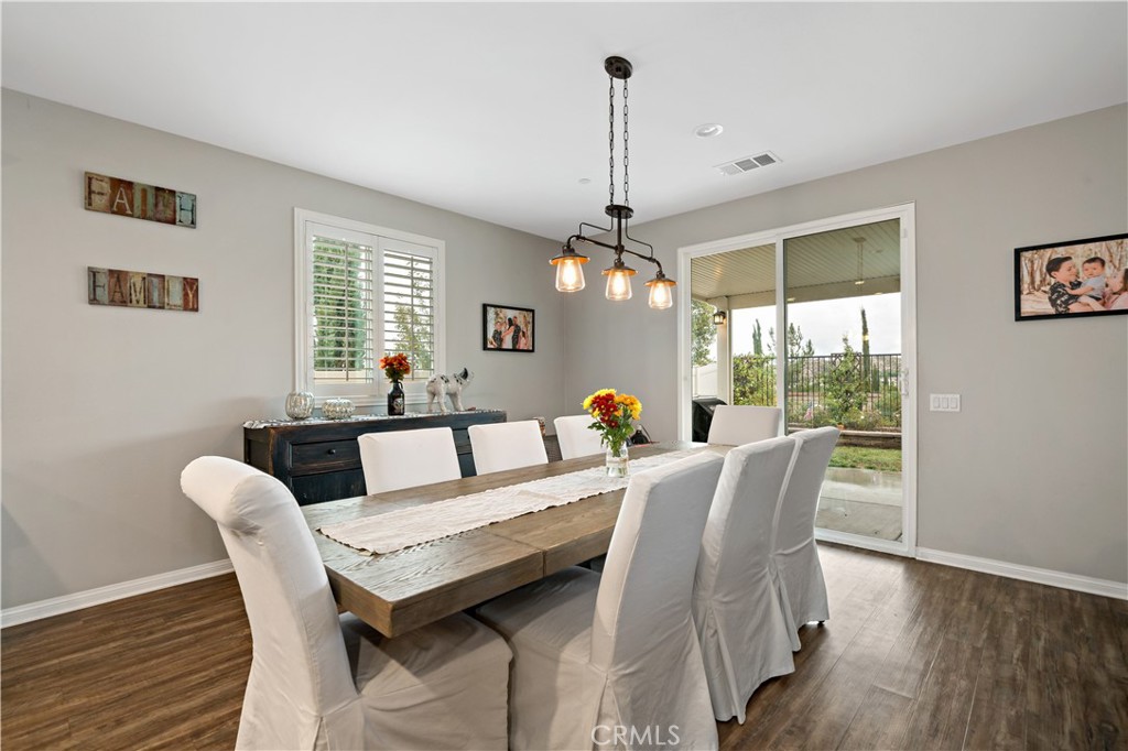 30640 Lone Pine Drive Menifee, CA 92584 - Photo 18 of 48 a view of a dining room with furniture window and wooden floor