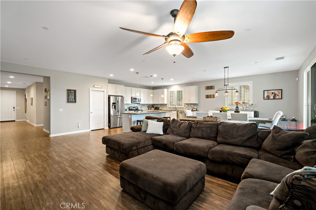 30640 Lone Pine Drive Menifee, CA 92584 - Photo 22 of 48 a living room with furniture kitchen view and a chandelier