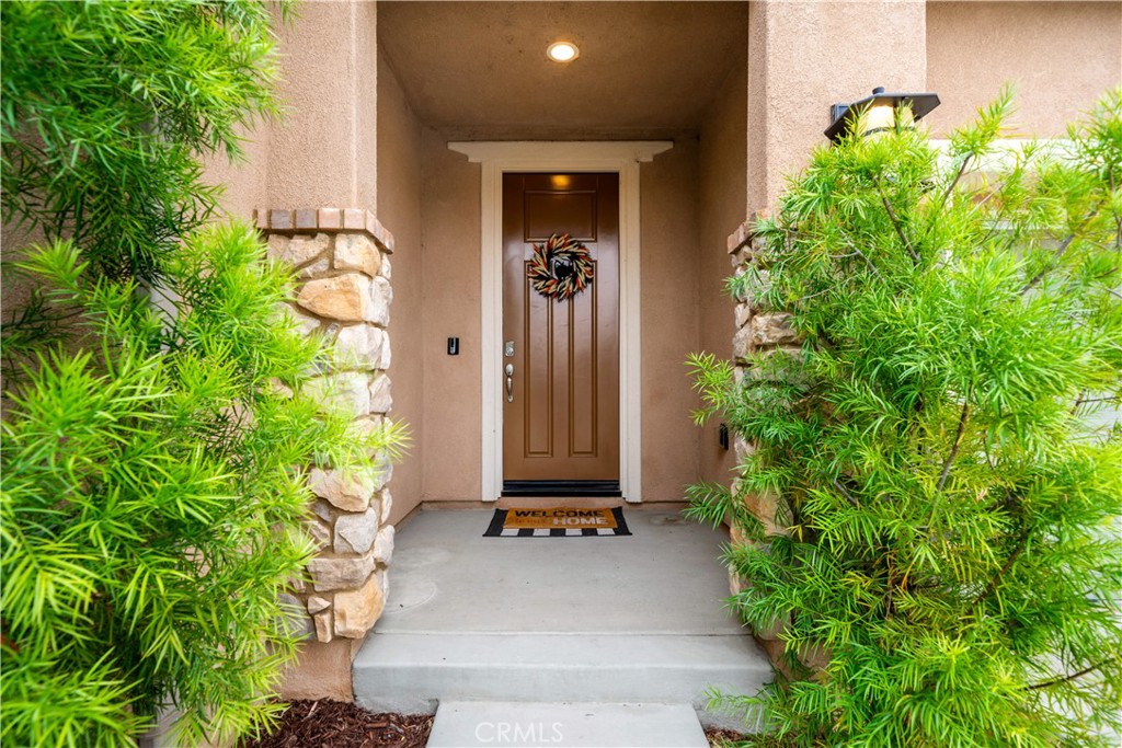 30640 Lone Pine Drive Menifee, CA 92584 - Photo 3 of 48 a view of a front door of house with a yard