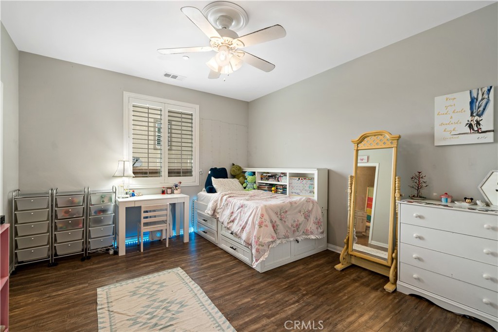 30640 Lone Pine Drive Menifee, CA 92584 - Photo 8 of 48 a bedroom with a bed and a chandelier